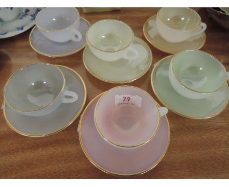 A set of six Arcopal harlequin glass cups and saucers