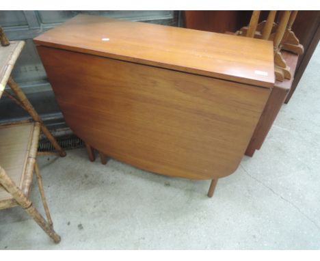 A vintage teak gateleg dining table