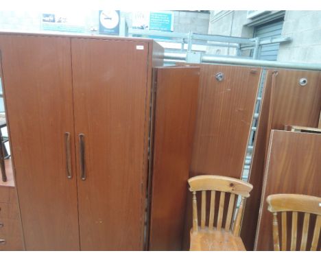 A pair of vintage G plan teak wardrobes, bearing labels for Gomme/Waring and Gillow