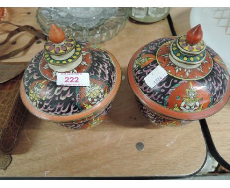 A pair of vintage oriental ceramic lidded jars with hand painted decoration