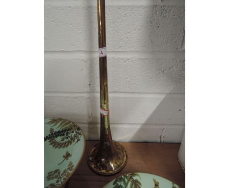 An antique brass hunting horn with crest marked J.Higham Ltd, makers 127.Strangeways Manchester no. 61741 4 ft long approx, 