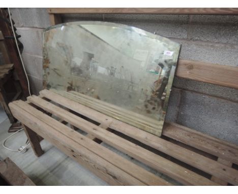 A vintage frameless wall mirror