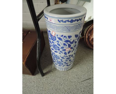 A tall standing ceramic umbrella stick stand in a delft ware style 