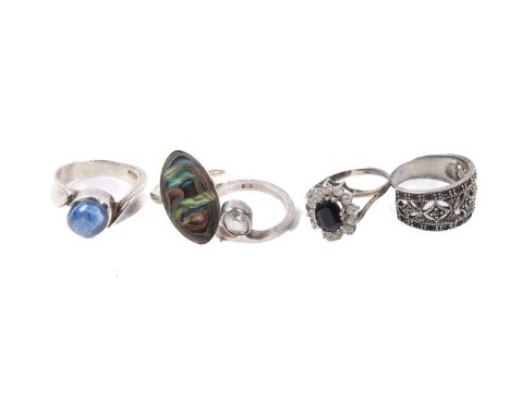 Five silver and white metal rings. Including a sapphire cluster ring stamped 'Silver', size O, a mother-of-pearl ring stamped
