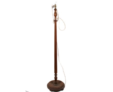 A turned wooden standard lamp. With a circular base. H148cm