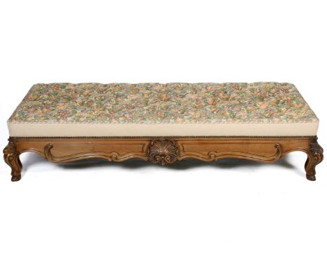 A contemporary large upholstered stool. Deep button upholstery raised on cabriole supports with carved shell and scroll motif