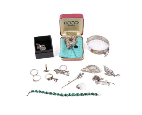 An assortment of silver and white metal jewellery. Including a bangle, 49.2g, a contemporary brooch modelled as a rose, a bro