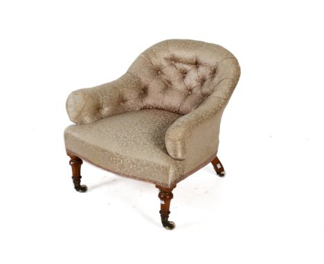 A Victorian button back tub armchair on turned walnut supports. Gold floral upholstery. H66cm