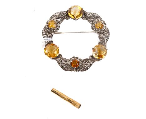  A Celtic style silver brooch set with round faceted citrines. Pin and roller catch fittings to reverse. Stamped 'SILVER'. 10