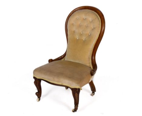A late 19th/early 20th century mahogany framed button back nursing chair. Velvet upholstery cabriole front supports terminati