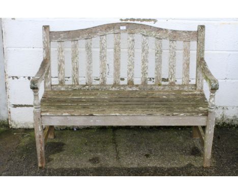 A Barlow Tyrie traditional two seater teak garden bench. H87cm x W116cm x D56cm