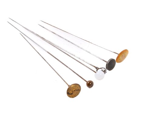 Six vintage hat pins. Including a white metal example topped with a blue enamel flower, one topped with a military button, et
