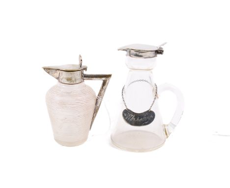 Two silver and silver plate mounted glass whiskey noggin jugs. One with a silver hinged lid and silver Whisky label on a chai