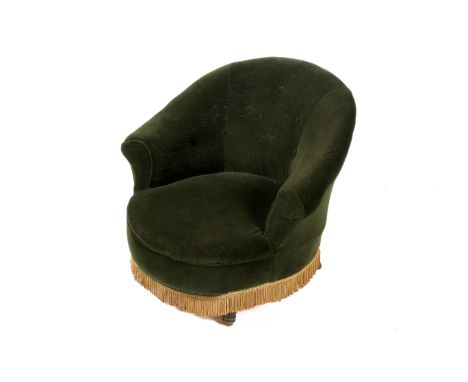 A green velvet upholstered button back tub chair. With gold fringe turned tapering front supports. H70cm