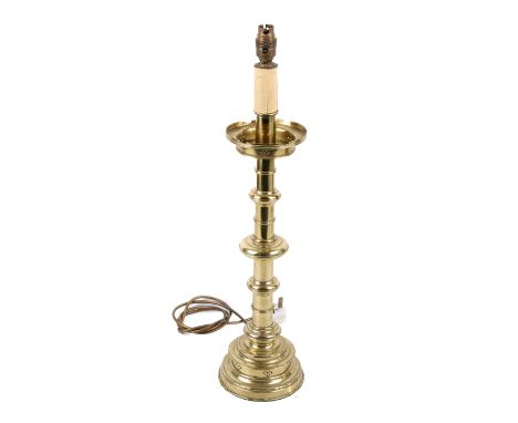 A 20th century ecclesiastical brass candlestick type table lamp. Raised on a round stepped plinth. H45cm