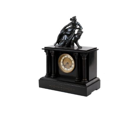 A Victorian black slate mantel clock. The white ceramic and gilt dial with Roman numerals, topped with a model of a goddess a