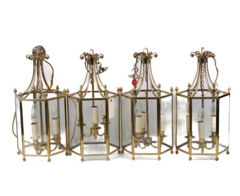 Four gilt metal hall lanterns. Of hexagonal form with three branch light fitting. H50cm