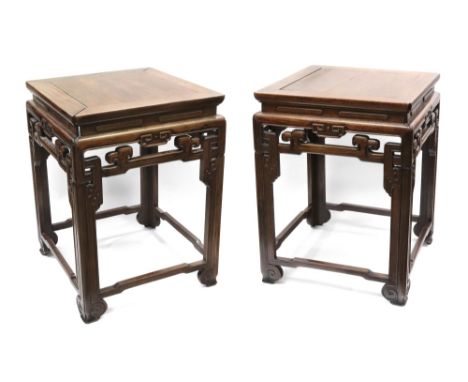 A pair of Chinese rosewood square low tables, 19th century, with scroll carved and pierced friezes and moulded square legs, u