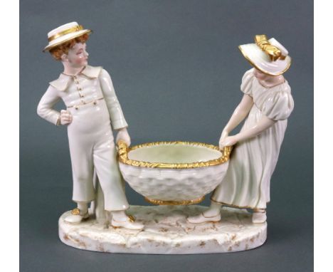 A Royal Worcester comport, circa 1886, modelled by James Hadley, with a boy and girl in Kate Greenaway style clothes carrying