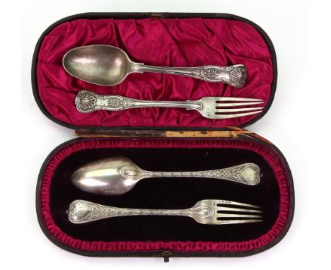 A child's cased Victorian silver spoon and fork, Edward Hutton, London 1888, with cast shell, bellflower and strapwork handle