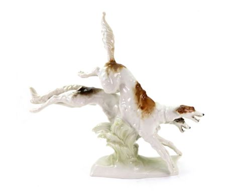 A Hutschenreuther group of two running hounds, circa 1930, modelled by Karl Tutter, blue printed mark, paper label, impressed