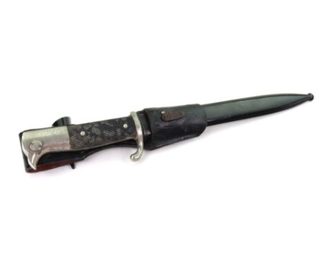 A German Second World War fire brigade ceremonial dress dagger, with 9¾" blade, in black leather scabbard.