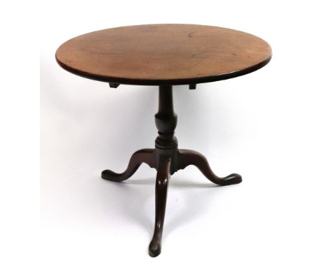 A George III mahogany tea table, the circular tilt-top on a vase turned pillar, the tripod base with pointed pad feet, 82cm d