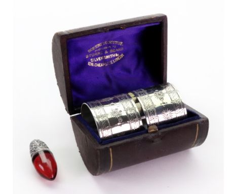 A cased pair of Victorian circular silver napkin rings, William Evans, Birmingham 1877, foliate engraved, and a miniature Vic