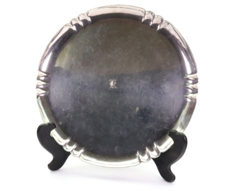 An Art Deco style shaped circular silver salver, R W Burbridge for Harrods, London 1957, with lobed and fluted raised sides, 