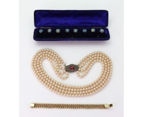 Costume jewellery comprising: a set of eight gilt-metal and turquoise enamel buttons, blue velvet case, an imitation three-ro