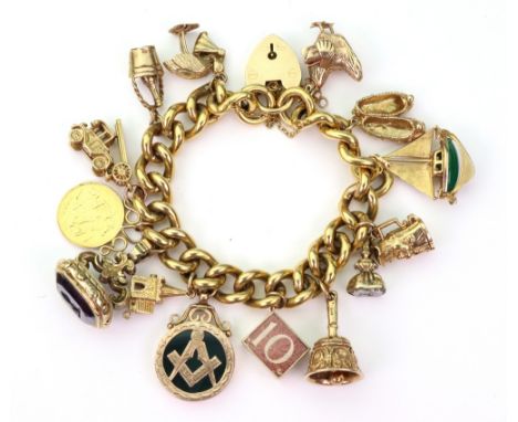 A 9ct yellow curb-link bracelet fitted with mostly 9ct charms comprising; pair of slippers, yacht, Toby jug, hand bell, emerg