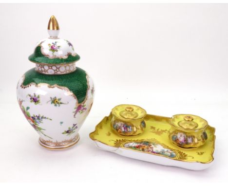 A Meissen porcelain inkstand, late 19th century, the shaped rectangular base and pair of inkwells and covers painted with rom