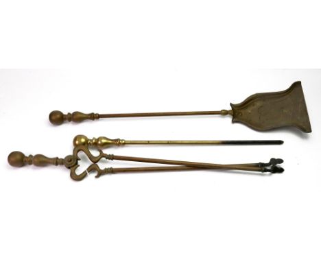 A set of three Victorian brass fire tools, with baluster and spherical capitals, the shovel of bell shape, 69.5cm long.