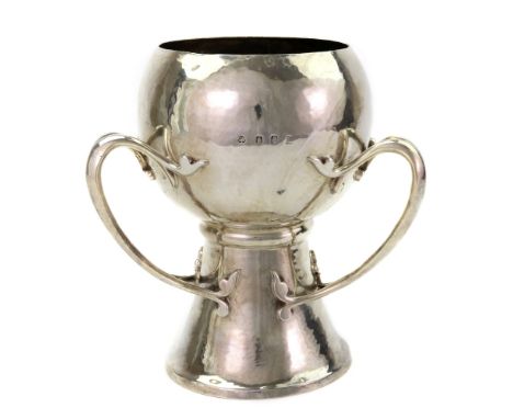 An Irish Art Nouveau silver spot hammered three handled cup (tyg), James & Frank Clarke Wheeler, Dublin 1903, circular, on a 