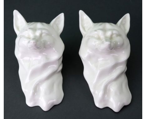 Two rare Royal Worcester white glazed fox heads, circa 1930, 11cm high. For the model see H Sandon, Royal Worcester Porcelain