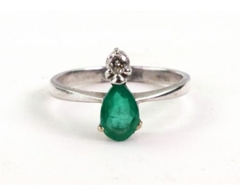A white gold, emerald and diamond ring, stamped 750, size R/S, 3.1g gross.