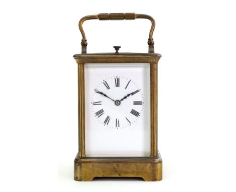 A large French brass carriage clock, circa 1900, in a corniche case, with push repeat and striking on a gong, the white ename