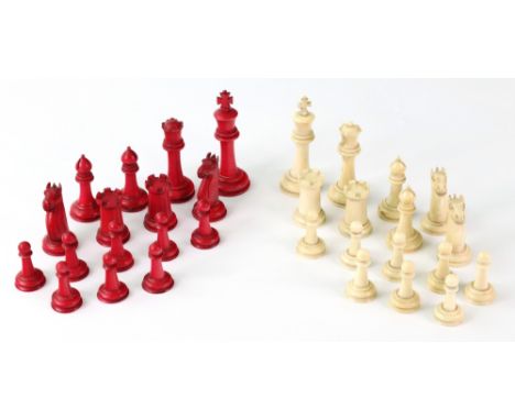 A turned and carved ivory chess set, 19th century, one half stained red, Kings 7cm high.