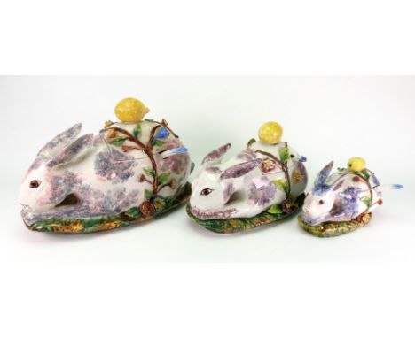 A graduated set of three Italian pottery novelty tureens in the form of rabbits, each with a ladle, 39 - 23cm.