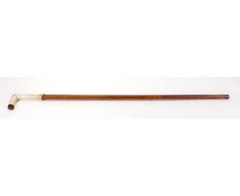 A Victorian sword stick walking cane, the copper mounted curved bone handle with a carved belt, 89cm long.