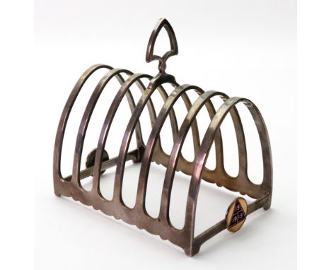 An Art Deco arched silver seven bar toast rack, Birmingham 1926, makers mark D & B, 10.5cm wide, 6ozs, applied with two circu