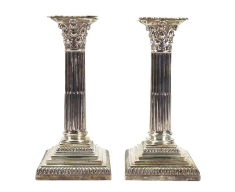 A pair of George III style silver Corinthian column candlesticks, William Hutton & Sons, London 1898, with gadroon borders, d