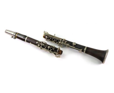 A rosewood clarinet with plated mounts, probably early 20th century, 66cm long, in velvet lined canvas covered carrying case.