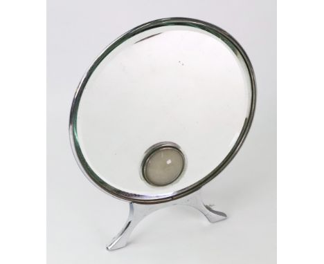 A Harcourts Art Deco chromium mounted table mirror, with circular bevel edge plate and projected inset lamp, 22cm diameter.