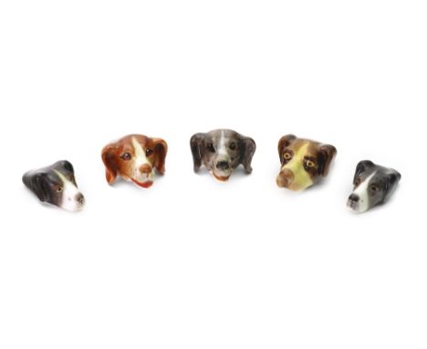 A group of five Royal Worcester hounds head whistles, circa 1920-1930, puce printed marks, 4cm - 5cm length (5). Illustrated