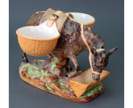 An unusual Royal Worcester porcelain cruet stand, circa 1870, modelled as a mule bending down to drink from a trough, carryin