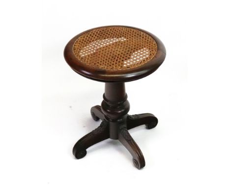 An early Victorian rosewood piano stool, the adjustable circular cane panel seat on a turned and cylindrical tapering pillar,