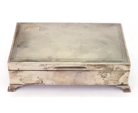 An Art Deco style silver cigarette box, Birmingham 1960, with hinged engine turned cover, on four ogee bracket feet, 15.5cm w