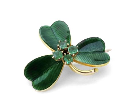 A yellow gold, emerald and green enamel Shamrock brooch, early 20th century, centred by a cluster of four small emeralds, sta