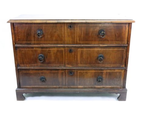 An early 18th century walnut and banded chest, altered, the later crossbanded moulded edge top above three long drawers, on l